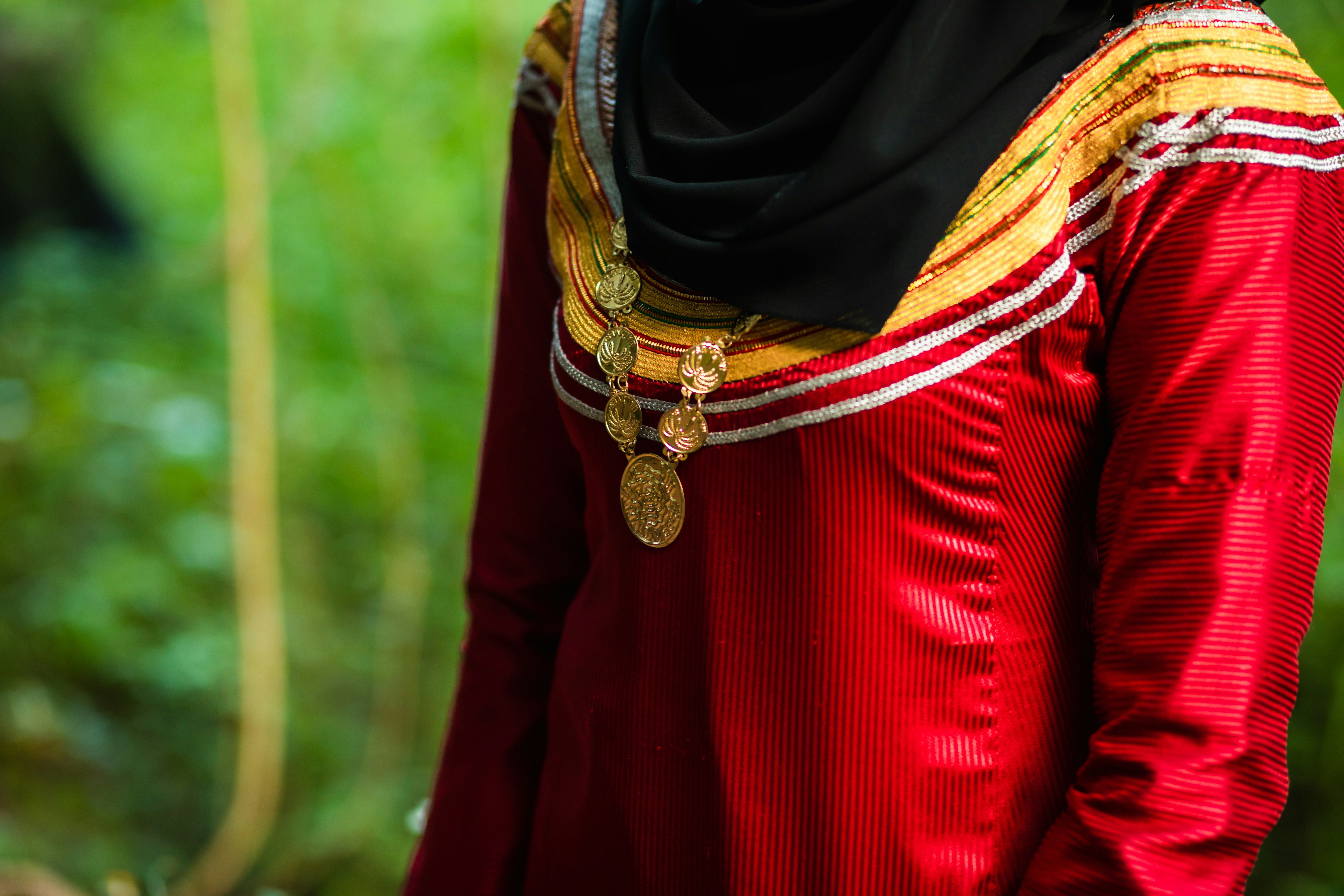 woman in black hijab and red long sleeve shirt